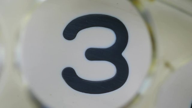 Three,. Extreme close-up of a finger dialing an old rotary pay phone. For creation countdown.
