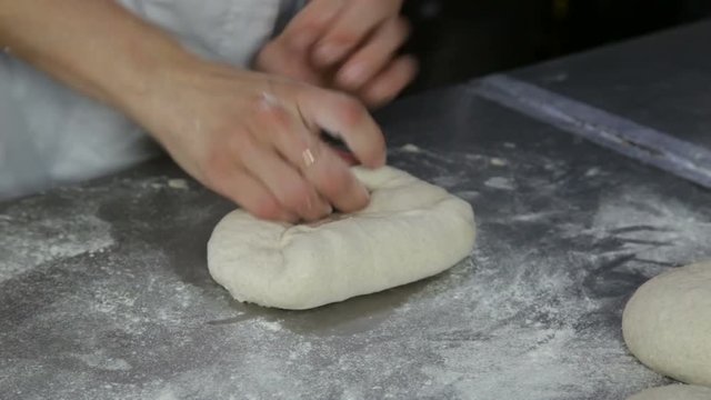 chef prepares bread to bake 