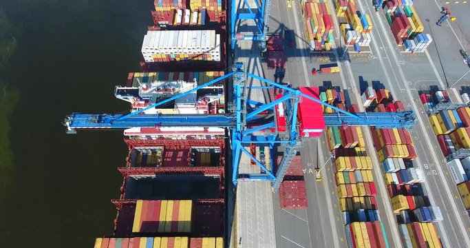 Aerial view of container ship anchored in the port and loaded with containers