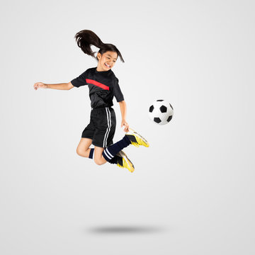 Fototapeta Young asian girl soccer player, Isolated on grey background