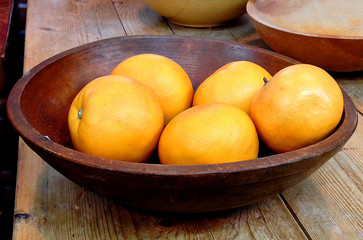 Wooden bowl with oranges
