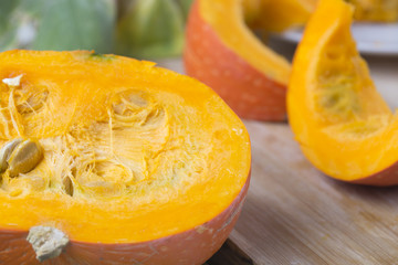     Pumpkin slices and seeds on the table. 