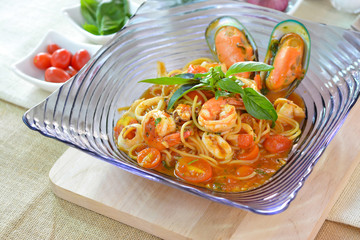 spaghetti seafood tomato sauce in purple glass plate