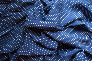 Rumpled fabric in blue and white with polka dot print