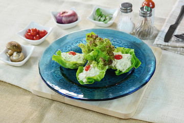 Crab salad with avocado in blue glass plate