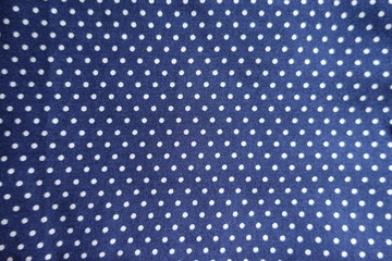 Surface of spotted blue fabric from above