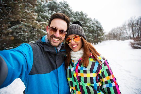 Romantic couple taking snow selfie