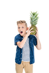 boy holding pineapple