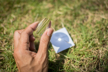 Merge sunlight with paper with a convex lens.