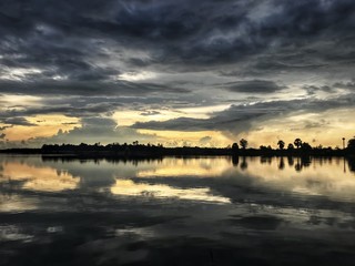Fototapeta na wymiar lake landscape and sky after raining in sunset