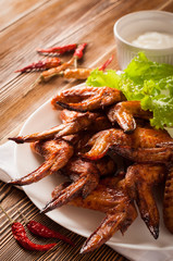 Grilled chicken wings on while plate
