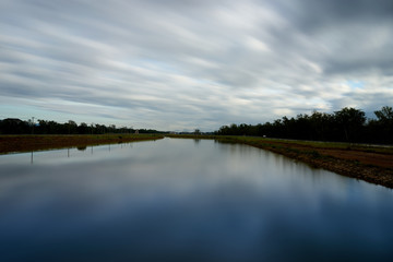 moving cloud over blue lake between forest