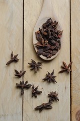 High angle close-up of star anise on wooden table.