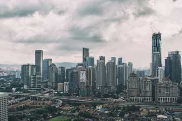 Fototapeta na wymiar Cityscape with cloudy sky and scyscrapers. Megapolis Kuala-Lumpur, Malaysia.