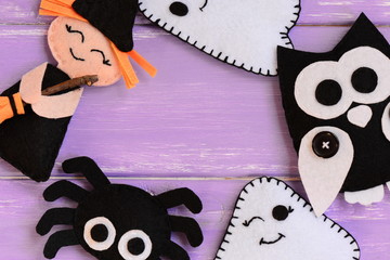 Quick Halloween crafts. Felt witch, ghosts, owl, spider decor on a wooden table. Felt Halloween handmade decor set. Easy sewing pattern for adults and kids. Top view