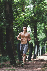 Young fit man running in the park