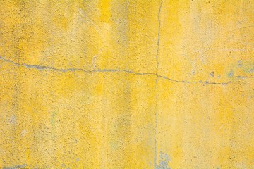Cracked yellow concrete wall texture