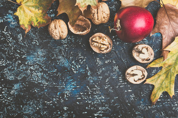 Apples  and walnuts on blue board