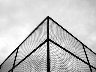 corner of cage metal wire at tennis court