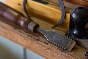 Wodcarving tools on wooden table , close up background 