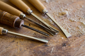 Wodcarving tools on wooden table , close up background 