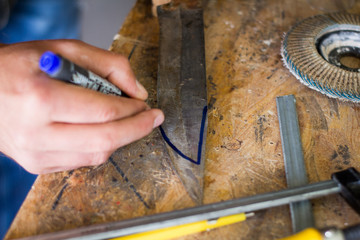 Close up picture of hand work with steel hunting blade 