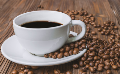 Black coffee and coffee bean on brown wooden table