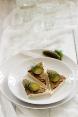 Canape with pate, canned cucumber and dill. Snack. Selective focus.