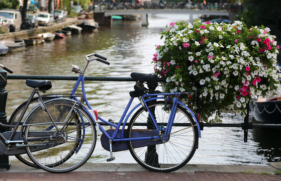 bicycles over to the bridge in the city of Amsterdam in the Neth