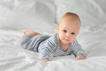 Portrait of a child four months on bed