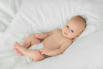 Portrait of a child four months on bed