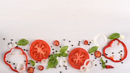 Vegetables background. Tomatoes, basil and garlic on white wooden table. Food background 