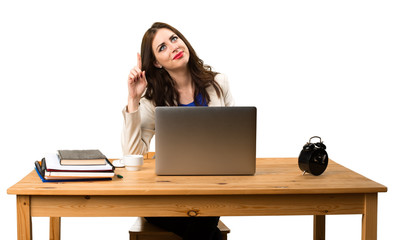 Business woman working with her laptop and pointing up