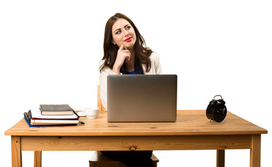 Business woman working with her laptop and thinking