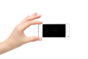 Woman's hand holds a white phone on a white background.