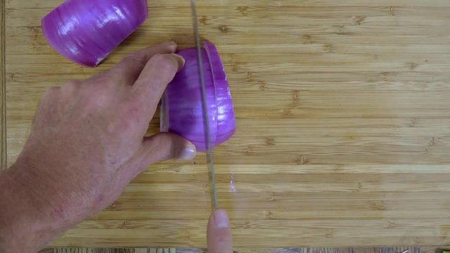 Overhead view of dicing a purple onion
