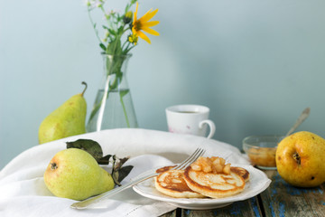 Pancake with pear compote, breakfast. Rustic style, selective focus.