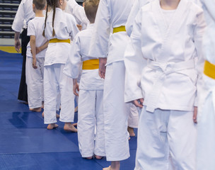 Children in kimono on martial arts training seminar. Selective focus