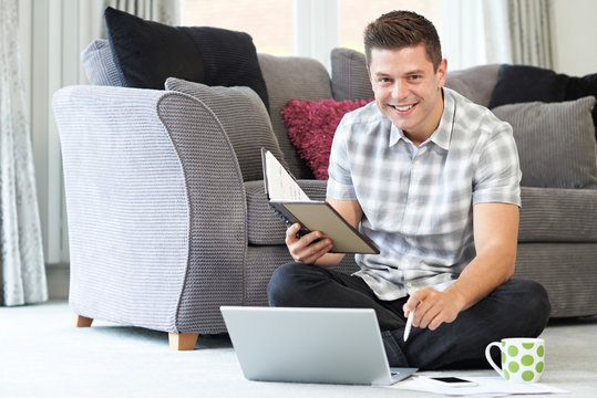 Male Freelance Worker Using Laptop At Home