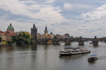 Cityscape view on the riverside with the bridge and old town in Prague