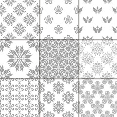 Gray and white floral ornaments. Collection of seamless patterns