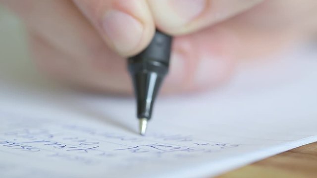 Extreme close up of a pen writing exam essay or letter