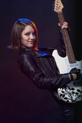 Fototapeta premium Young attractive rock girl playing the electric guitar