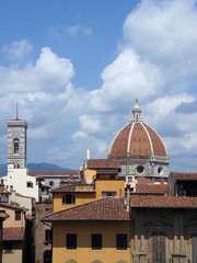 Fototapeta na wymiar Dome of the Cathedral of Saint Mary of the Flower (Cattedrale di Santa Maria del Fiore, Duomo) and roofs of buildings of Florence (Firenze), Italy