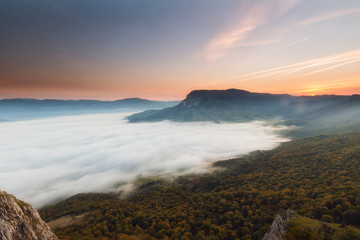 Autumn forest over the clouds in Andia