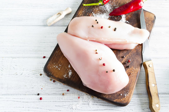 Raw chicken meat on wooden cutting