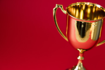 Gold winners trophy cup on a red background