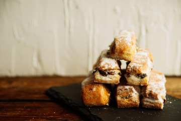 Strudel Apple and sugar powder. Biscuit from the puffed Test on the Gray Background. Dessert with Fruits.Copy space for Text. selective focus.