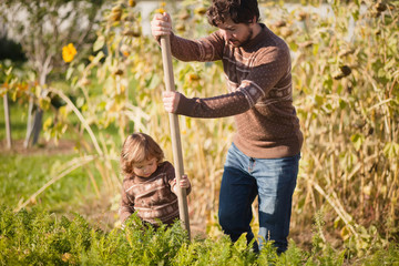 Father and child working in the garden.