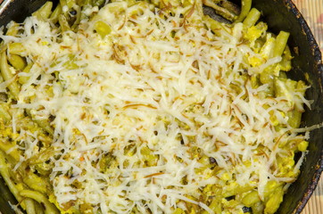 String beans, fried with egg and sprinkled with grated melted cheese.